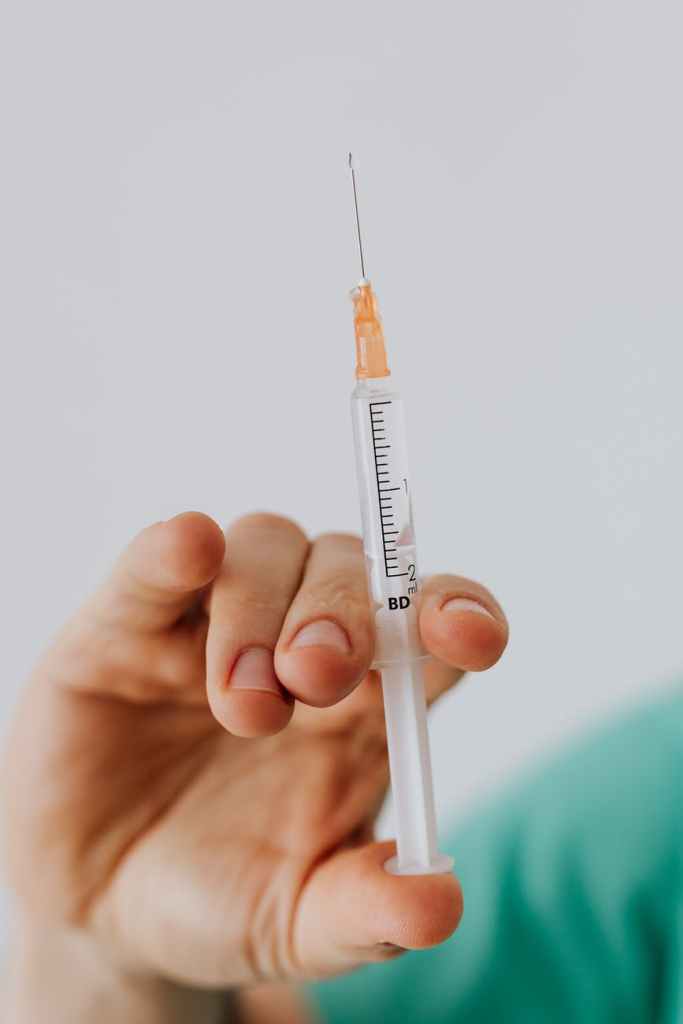 insulin syringe in hand