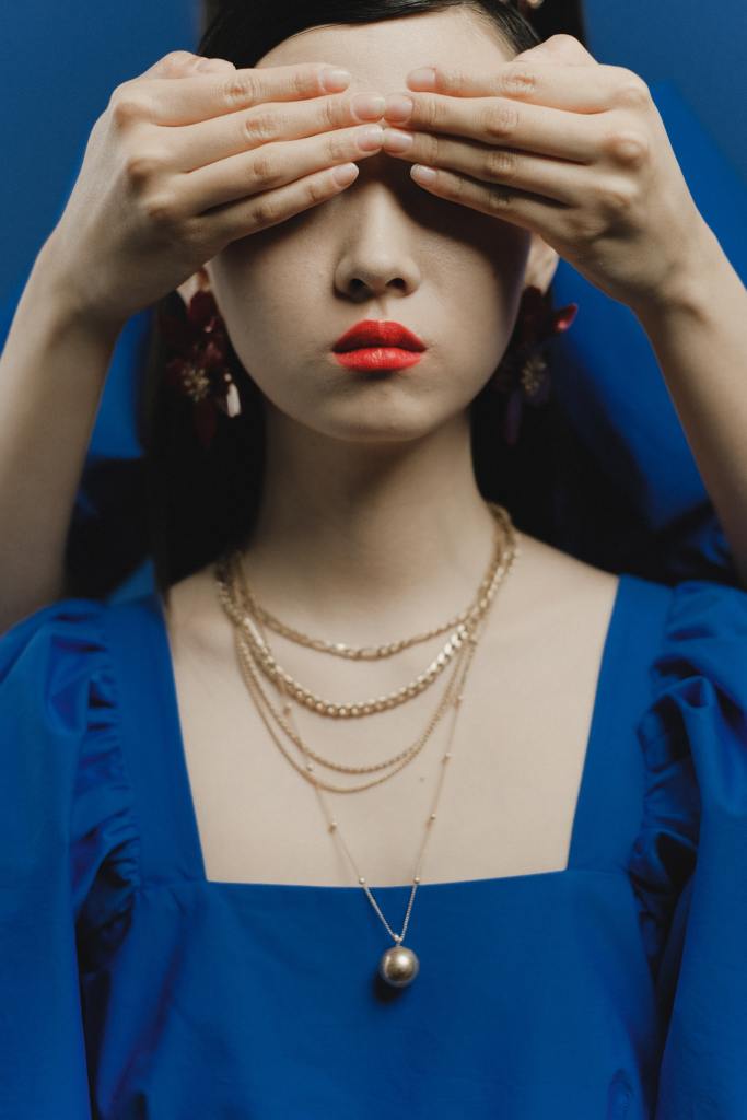 Woman with hands over eyes